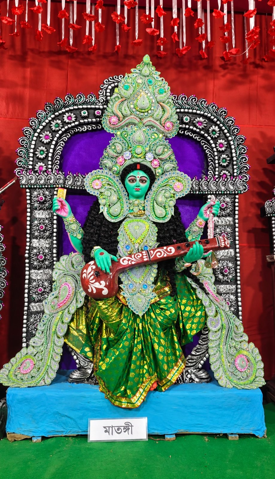 Maa Matangi in green, playing the veena, with her nameplate 'মাতঙ্গী' below